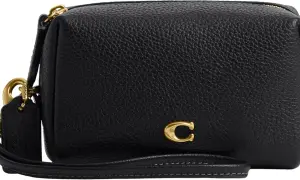Bolso negro de piel texturizada de Coach con detalle de "C" dorada y correa de mano.